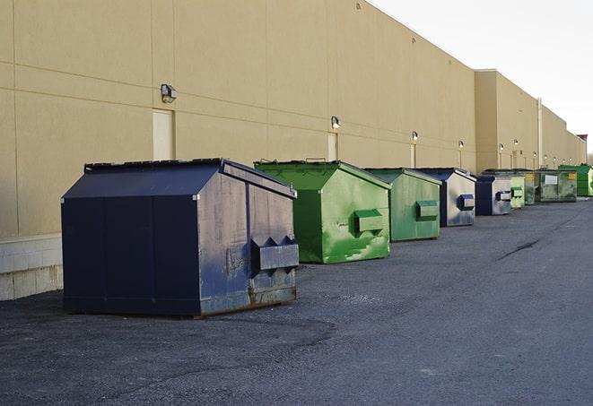 a row of yellow and blue dumpsters at a construction site in Archbald PA